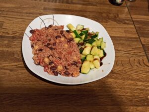 Teller mit Couscous-Eintopf und Zucchini