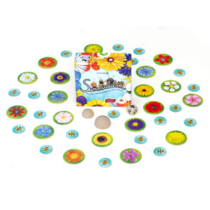 Das Spiel "Sumsalabim" steht in der Mitte umringt von Hummel-und Blütenplättchen, die das Spielmaterial bilden.
